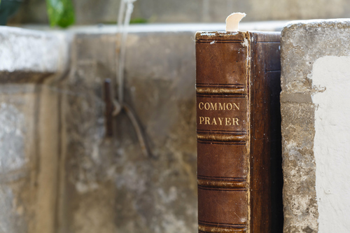 leather bound common prayer book sitting on an old shelf