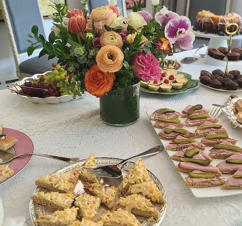 breakfast table with flowers and food